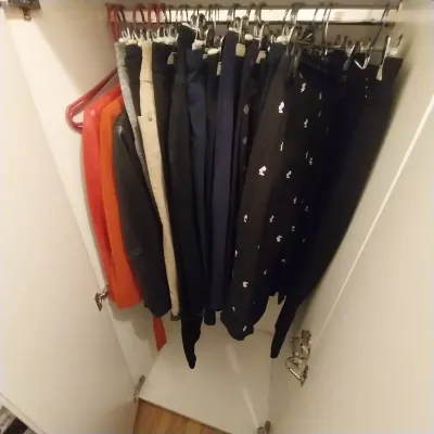 Sale Photo Thumbnail #20: Closet filled with hanging modern women's clothing, including pants and jackets on various hangers.