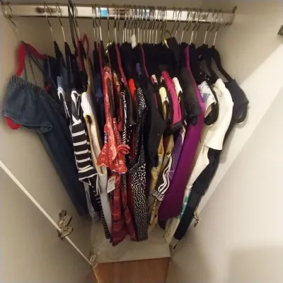 Sale Photo Thumbnail #23: Closet filled with women's contemporary clothing, including various dresses, tops, and patterns hanging on metal clothes hangers.