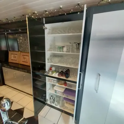 Sale Photo Thumbnail #31: Tall modern black and white pantry cabinet with open glass doors, filled with stemware and kitchen storage containers.