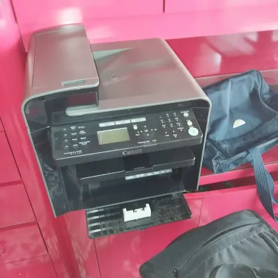 Sale Photo Thumbnail #17: Canon imageCLASS all-in-one laser printer and scanner unit sitting on a bright pink surface.