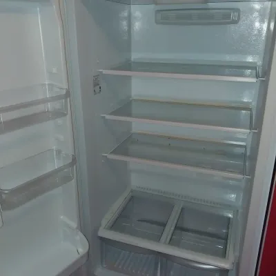 Sale Photo Thumbnail #13: Interior view of a clean white refrigerator featuring adjustable glass shelves, door bins, and dual crisper drawers.