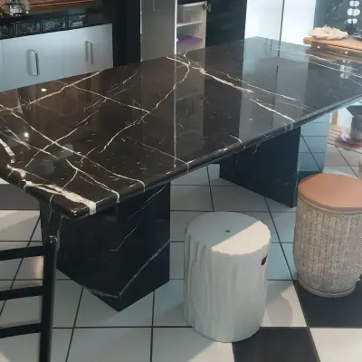Sale Photo Thumbnail #2: Large black marble dining table with prominent white veining and twin pedestal bases, surrounded by various decorative stools.