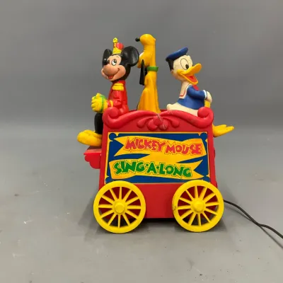 Sale Photo Thumbnail #288: Vintage Disney Mickey Mouse Sing-A-Long electric music box wagon toy, featuring molded plastic figures of Mickey, Pluto, and Donald Duck.
