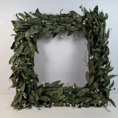 Sale Photo Thumbnail #96: Square artificial greenery wreath decorated with faux bay leaves, white berries, and clear bead accents.