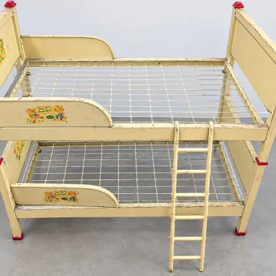 Sale Photo Thumbnail #159: Vintage metal doll bunk bed by Wolverine, featuring cream paint with nursery graphics, wire spring supports, and an attached ladder.