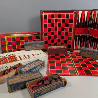 Sale Photo Thumbnail #351: Collection of vintage checkers and backgammon board games, including folding game boards, original boxes, and game pieces.