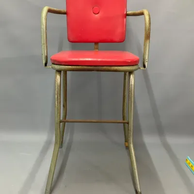 Sale Photo Thumbnail #261: Vintage mid-century industrial counter chair with red vinyl upholstery and a distressed metallic frame.