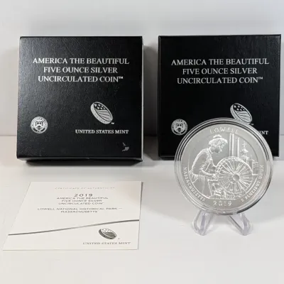 Sale Photo Thumbnail #9: 2019 Lowell National Historical Park America the Beautiful 5-ounce silver uncirculated coin, accompanied by two original US Mint presentation boxes and a Certificate of Authenticity.