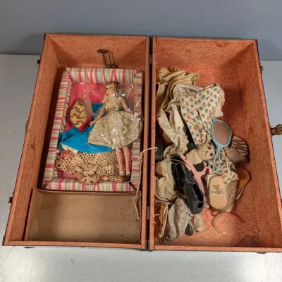 Sale Photo Thumbnail #169: Vintage doll trunk filled with a fashioned blonde doll, miniature clothing, shoes, a mirror, and small accessories.
