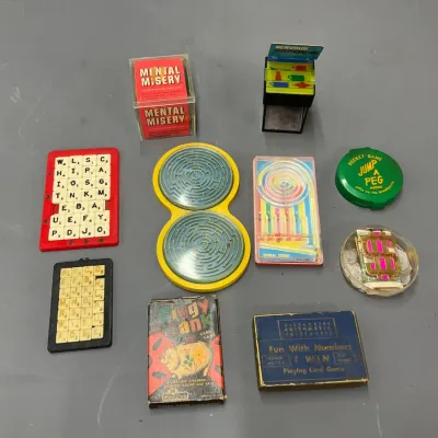 Sale Photo Thumbnail #302: Collection of vintage mini puzzle and card games, including Mental Misery, Jump a Peg, and Fun With Numbers.