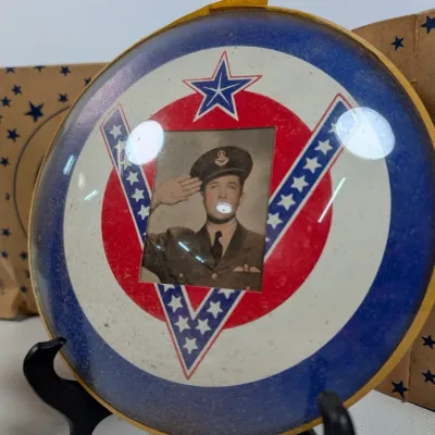Sale Photo Thumbnail #76: Vintage World War II era convex glass framed military portrait featuring a saluting soldier within a patriotic red, white, and blue V-for-victory motif.