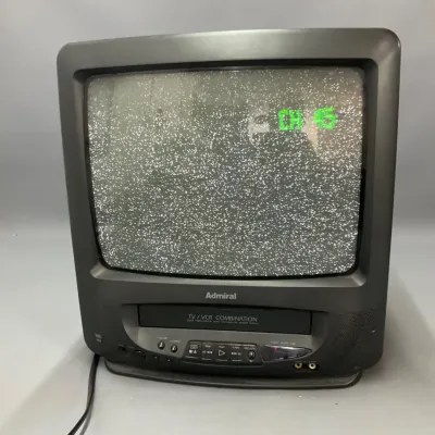 Sale Photo Thumbnail #258: Vintage Admiral CRT TV/VCR combination unit in a black casing, shown powered on with static on screen.