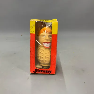 Sale Photo Thumbnail #244: Vintage 1976 Jimmy Carter peanut novelty figure in its original red and yellow display box.