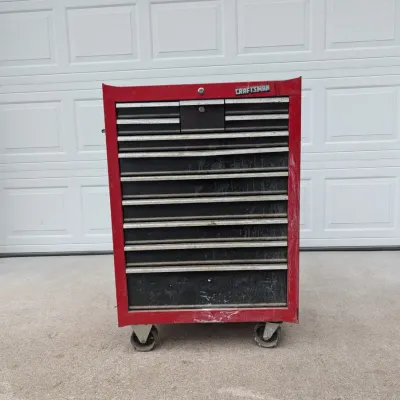 Sale Photo Thumbnail #66: Red Craftsman rolling tool chest featuring multiple drawers with aluminum trim handles and heavy-duty casters.