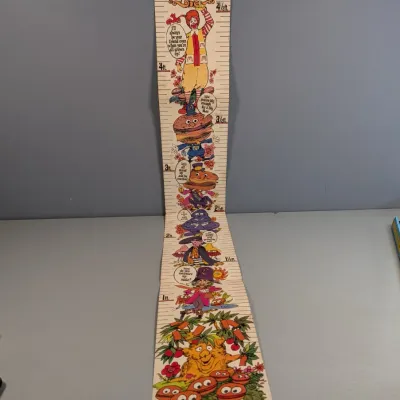Sale Photo Thumbnail #441: Vintage 1970s McDonaldland paper growth chart featuring Ronald McDonald and classic characters. Shows light age-related wear with creasing.