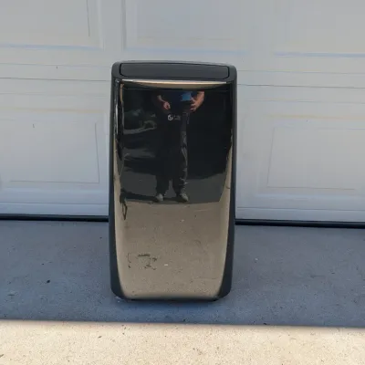 Sale Photo Thumbnail #247: Black LG portable air conditioner unit, showing minor surface scuffs.