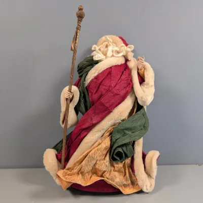 Sale Photo Thumbnail #150: Vintage handmade Santa Claus figure holding a staff, dressed in layered fabric robes with faux fur trim.