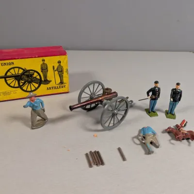 Sale Photo Thumbnail #364: Vintage Wm. Britains Union Artillery toy set with original box, featuring a die-cast cannon, Union soldier figurines, and accessories.