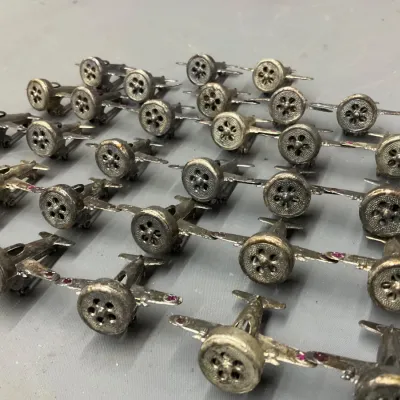 Sale Photo Thumbnail #243: Large collection of vintage miniature metal airplane brooches or pins, detailed with radial engines and red stone accents.