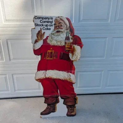 Sale Photo Thumbnail #262: Vintage Coca-Cola cardboard Santa Claus standee reading "Company is Coming! Stock up on Coke," showing moderate edge wear and creasing.