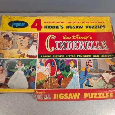 Sale Photo Thumbnail #345: Vintage Jaymar Walt Disney's Cinderella pre-school inlaid stay-in-tray 4 kiddie's jigsaw puzzles set, featuring original box with visible edge wear.