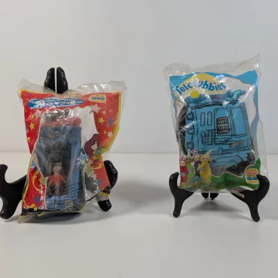 Sale Photo Thumbnail #430: Two vintage 1999 Burger King Kids Club meal toys in original sealed packaging, including a Nickelodeon Kids Choice Awards toy and a Teletubbies toy.