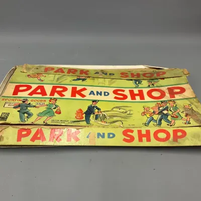 Sale Photo Thumbnail #219: Vintage Milton Bradley Park and Shop board game box showing heavy wear and tape repairs along the edges.