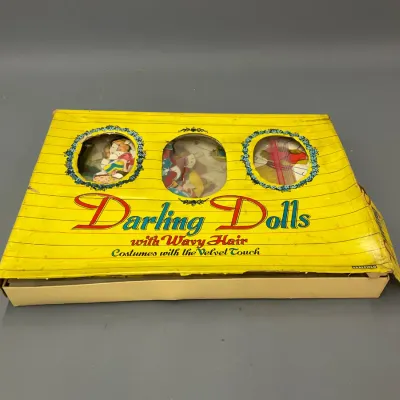 Sale Photo Thumbnail #109: Vintage 'Darling Dolls with Wavy Hair' paper doll set by Saalfield in its original yellow box, showing wear and creasing.
