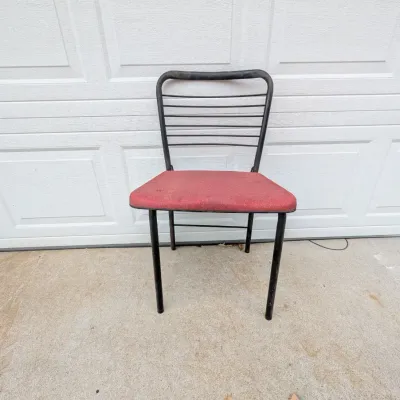 Sale Photo Thumbnail #61: Vintage metal-framed dining chair with a horizontal wire backrest and red upholstered seat, displaying light surface wear.
