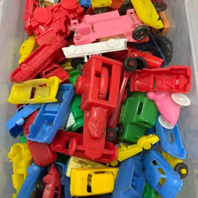 Sale Photo Thumbnail #393: Large clear storage bin filled with assorted vintage molded plastic toy cars, trucks, and Burger King promotional vehicles.