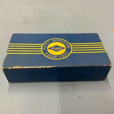 Sale Photo Thumbnail #234: Vintage Lowe plastic interlocking poker chips in original blue and yellow cardboard box showing mild edge wear.
