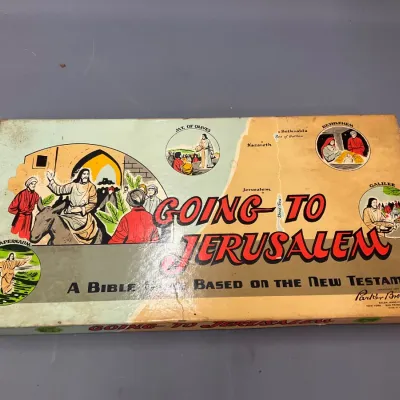 Sale Photo Thumbnail #241: Vintage Parker Brothers "Going to Jerusalem" Bible board game, circa 1955. The box shows minor edge wear and light yellowing consistent with age.