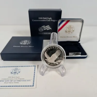 Sale Photo Thumbnail #2: 2008 Bald Eagle Commemorative Proof Silver Dollar from the United States Mint, displayed on a plastic easel with its original velvet presentation case, outer box, and Certificate of Authenticity.