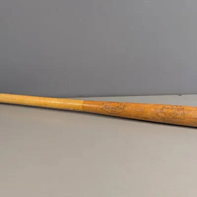 Sale Photo Thumbnail #443: Vintage Adirondack Big Stick wooden baseball bat with a taped grip, showing signs of wear and age.