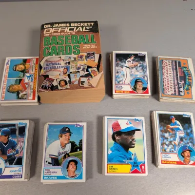 Sale Photo Thumbnail #382: Collection of vintage Topps baseball card stacks alongside a 1991 Dr. James Beckett Official Price Guide to Baseball Cards book.