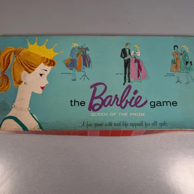 Sale Photo Thumbnail #199: Vintage 1960 Mattel "The Barbie Game: Queen of the Prom" board game box with classic illustrations.
