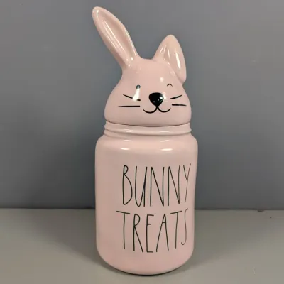 Sale Photo Thumbnail #120: Pink Rae Dunn ceramic "BUNNY TREATS" canister featuring a rabbit-shaped lid.