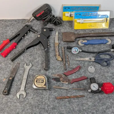Sale Photo Thumbnail #92: Assorted vintage hand tools, hardware, and accessories including a Weller soldering gun, rivet tools, Olympia tape measure, wrenches, and pruners.