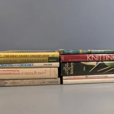 Sale Photo Thumbnail #28: Collection of vintage craft, knitting, and needlework instructional books, showing varied shelf wear.