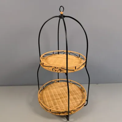 Sale Photo Thumbnail #123: Two-tier woven wicker and black metal display stand featuring birdcage-style arched metal wire frame and top ring handle.