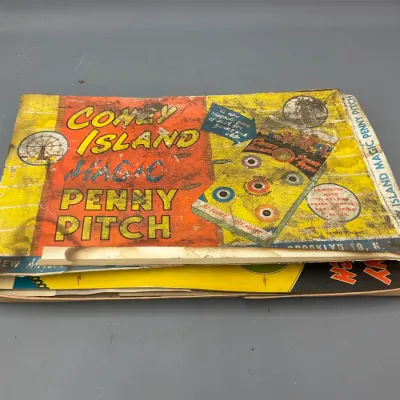 Sale Photo Thumbnail #240: Vintage Coney Island Magic Penny Pitch magnetic game in original box, showing significant edge wear and cardboard creasing.