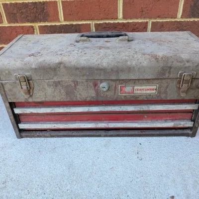 Sale Photo Thumbnail #94: Vintage Sears Craftsman metal portable toolbox featuring two red drawers, a top storage compartment, and double latch closures with surface rust and age-related patina.