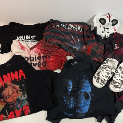 Sale Photo Thumbnail #40: Collection of horror movie-themed apparel, including graphic t-shirts featuring Chucky and Hellraiser, a Freddy Krueger top, a full-zip hoodie, and matching Ghostface print sneakers.