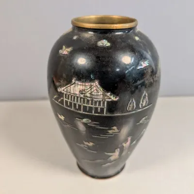 Sale Photo Thumbnail #175: Vintage black lacquer vase featuring intricate mother-of-pearl inlay depictions of a pagoda landscape, birds, and figures.
