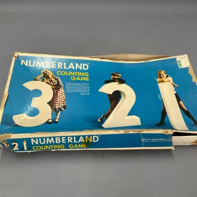 Sale Photo Thumbnail #239: Vintage Numberland Counting Game in its original box, showing significant edge wear and cardboard damage.