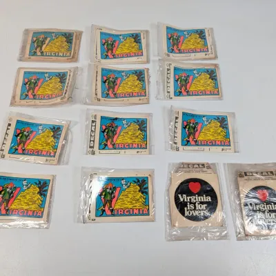 Sale Photo Thumbnail #431: Collection of vintage Virginia souvenir decals, including illustrated state map designs and classic "Virginia is for lovers" decals, all sealed in original packaging.