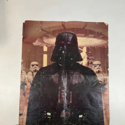 Sale Photo Thumbnail #98: Vintage Star Wars Darth Vader folded poster featuring Stormtroopers in the background, showing wear and creasing along the fold lines.