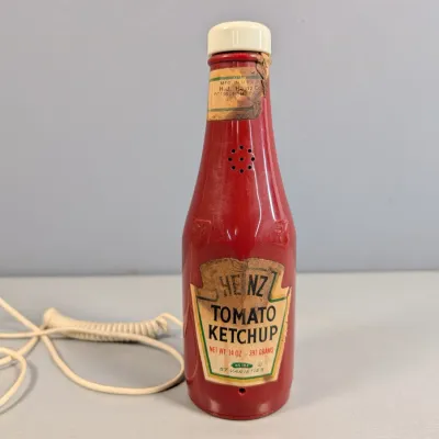 Sale Photo Thumbnail #336: Vintage novelty Heinz Tomato Ketchup bottle landline telephone with coiled cord, displaying visible label wear and aging.