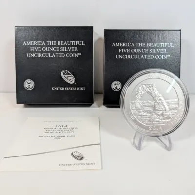 Sale Photo Thumbnail #5: 2014 United States Mint 'America the Beautiful' 5 oz silver uncirculated coin featuring Arches National Park, complete with protective capsule, stand, certificate of authenticity, and presentation boxes.