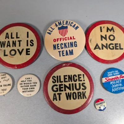 Sale Photo Thumbnail #371: Collection of seven vintage novelty pinback buttons, including mid-20th-century humorous slogans and political campaign pins.